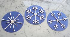 three snowflakes are sitting on a marble surface