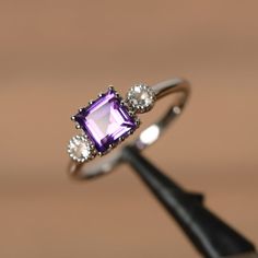 a ring with an amethorate and diamonds on it