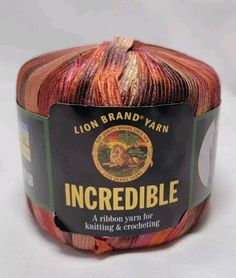 lion brand yarn incrediblee yarn in red, orange and brown colors on a white background