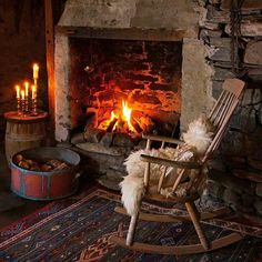 a rocking chair sitting in front of a fire place