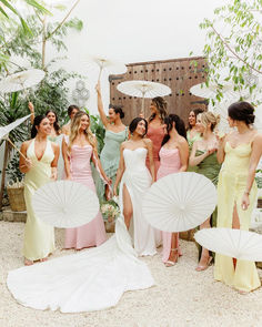 a group of women standing next to each other with umbrellas in front of them