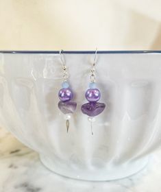 This pair of silver plated earrings feature nickel free ear wires, hoops, along with amethyst chunk beads, light purple faux pearls and lavender and white faceted glass rondelle beads and a silver spacer on spear posts. Each pair of earrings comes with silicone stoppers to hold the earring in place securely. This pair measures 2 inches in length.  o ~ TURNAROUND TIME ~ Ready to ship items, such as earrings, will ship in 1-2 business days.  o ~ CUSTOMER CARE ~ Please contact us if you have any qu Nickel-free Lavender Earrings Gift, Nickel-free Amethyst Lavender Earrings, Adjustable Lavender Sterling Silver Earrings, Nickel-free Lavender Amethyst Earrings, Gift Lavender Nickel-free Earrings, Nickel-free Purple Dangle Hoop Earrings, Purple Nickel-free Dangle Hoop Earrings, Nickel Free Amethyst Dangle Earrings, Nickel-free Amethyst Dangle Earrings