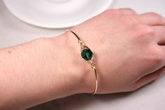 Rose Gold Emerald Swarovski Crystal Bracelet Handmade by Jessica Luu Jewelry ~ Faceted ~ Versatile ~ Elegant ~ With every wave of your hand, there will be a sparkle of emerald green at your wrist as this bangle moves around. Emerald is the birthstone for May making this a thoughtful birthday gift for someone special. MATCHING ITEMS https://www.etsy.com/shop/JessicaLuuJewelry?search_query=emerald MATERIALS: ~ 10mm emerald Swarovski crystal ~ 14K gold filled wire HOW IT'S MADE: A large Swarovski c Bangle Bracelet Gold, Emerald Bracelet, Swarovski Crystal Jewelry, Jewelry Bracelets Gold, Swarovski Crystal Bracelet, Stone Bangle, Gold Bangle Bracelet, Rose Gold Bracelet, Green Crystal