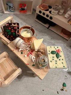 a wooden table topped with lots of different types of food and confection items