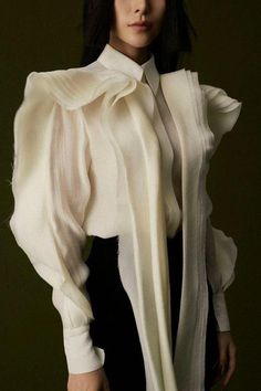 This top is was made with wavy-folded tailoring creates flexibility when you wear it. Structured Fashion, Ruffle Long Sleeve Blouse, Big Sleeves, Mean Blvd, Ruffle Sleeve Blouse, Sleeves Blouse, Ruffle Long Sleeve, Blouse Material, Fashion Inspiration Design