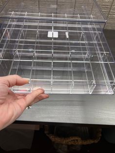 a person is holding a clear plastic drawer