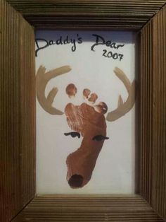 a frame with a handprint of a deer and the words daddy's dear zoo on it