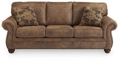 a brown couch with two pillows on it