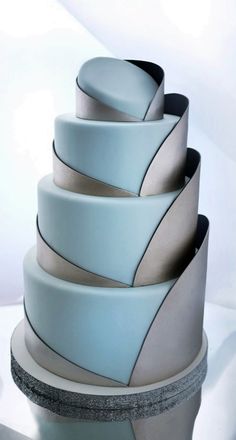 a white and blue cake sitting on top of a table