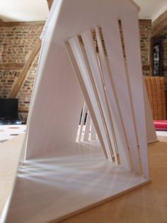 a white sculpture sitting on top of a wooden table