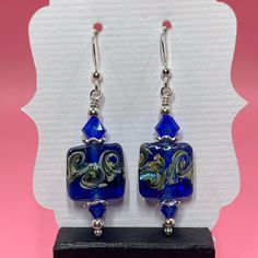 These earrings are made with blue swirl lampwork beads, blue Swarovski crystals, sterling silver spacer beads and  small round sterling silver beads. They measure approximately 2 inches from the top of the sterling silver earwire. Click here to see other earrings in my shop: https://www.etsy.com/shop/JewelryDesignsByRita?section_id=14765680 I have been designing and making jewelry since 2010. I use only the highest quality materials such as Swarovski crystals, Swarovski pearls, gemstones, sterling silver, Gold Vermeil, gold filled components and artisan made lampwork beads. If you have any questions as you browse, please feel free to ask. Self-Representing Artist in Jewelry Design, Member #3879 Nickel-free Blue Beaded Sterling Silver Earrings, Blue Sterling Silver Earrings With Silver Beads, Adjustable Blue Earrings With Silver Beads, Blue Sterling Silver Wire Wrapped Beaded Earrings, Blue Wire Wrapped Sterling Silver Beaded Earrings, Blue Sterling Silver Dangle Beaded Earrings, Blue Czech Glass Beaded Earrings Wire Wrapped, Blue Czech Glass Wire Wrapped Beaded Earrings, Blue Silver-plated Wire Earrings