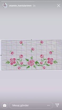 a cross stitch pattern with pink flowers and green leaves on the bottom half of it