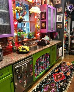 the kitchen is decorated in bright colors and has an area rug on the floor that matches with the green cabinets