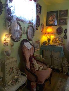 a living room filled with furniture and pictures on the wall