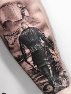 a man with a hot air balloon tattoo on his arm is walking through the water