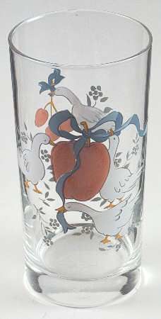 a glass with an image of two birds on the bottom and one bird holding a heart