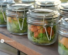 four mason jars filled with different types of food