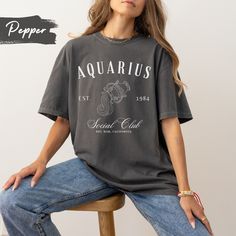 Embrace your Aquarius pride with our exclusive Aquarius Zodiac Sign T-shirt, featuring a captivating Aquarius figure and the bold insignia 'Aquarius Social Club'. Crafted with premium quality fabric, this shirt is the perfect way to showcase your astrological spirit and stand out in style. Customize it and make it a perfect gift for your friends and family.  Note: The font colors will match the pictured shirt colors. (See images for matching font colors) .: 100% ring-spun cotton .: Medium fabric Raccoon Tshirt, Galaxy Shirt, Vintage Cartoons, Tummy Ache, Feyre And Rhysand, 90s Shirts, Espresso Martini, Negroni, Sarah J Maas