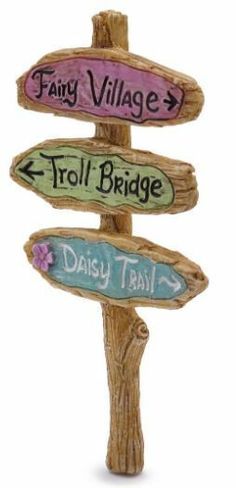 a wooden sign that says fairy village, troll bridge and daisy trail with arrows pointing in different directions