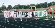 cheerleaders holding a sign that says no pitty or the kitties