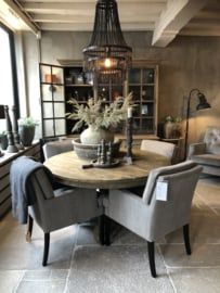 a dining room table with chairs and a chandelier hanging from it's ceiling