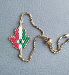 This is an Elegant beaded bracelet featuring Hamsa Palm, it's braided by hand in Italian flag colors and attached to an adjustable stainless steel chain.  This beautiful bracelet makes a beautiful and thoughtful Malocchio protection jewelry and a perfect gift for your loved ones.  Metal parts are made of high quality stainless steel, it's hypoallergenic and durable  All our items are custom made, it takes 3-5 days to get your order prepared.  The delivery date will depend on your location.  * USA - 2 - 4 weeks * Canada - 2 - 5 weeks * Europe - 2-3 weeks * Other - 2 - 4 weeks Please read our frequently asked questions FAQ to find out more Hand-strung Chain Bracelet With Round Beads As Gift, Hand-strung Round Beads Chain Bracelet As Gift, Hand-strung Adjustable Chain Bracelet For Gift, Adjustable Hand-strung Chain Bracelet As Gift, Handmade Adjustable Chain Bracelet For Friendship, Adjustable Multicolor Chain Bracelet, Bohemian Beaded Bracelets With Adjustable Chain, Bohemian Beaded Bracelets With Adjustable Chain As Gift, Handmade Adjustable Chain Bracelet With Round Beads