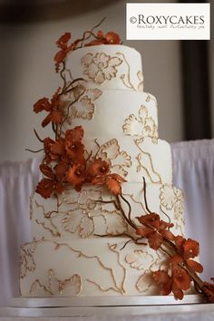 a wedding cake with orange flowers on it