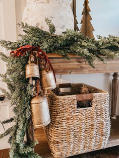 a christmas mantle with bells and evergreen garland