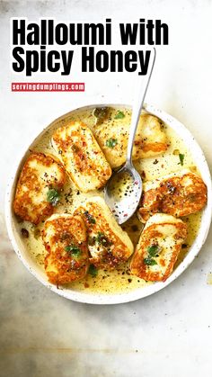 a white bowl filled with food on top of a marble counter next to a spoon