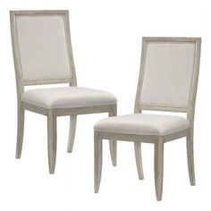 two white chairs sitting next to each other