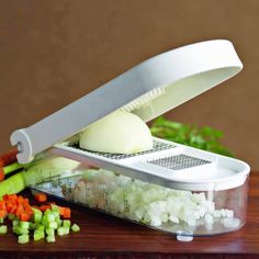 a cutting board with diced vegetables and a grater