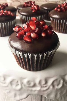 cupcakes with chocolate frosting and pomegranate toppings on top