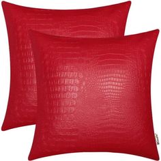 two red pillows with crocodile skin pattern on the front and back, both in different colors