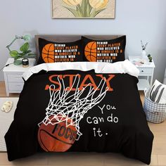 a bed with black comforter covers and basketballs on the cover, in a bedroom