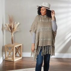 The Khaki Meegan Poncho can be worn for fashion, warmth, and comfort during the fall and winter months. Add a stylish touch to an outfit for any occasion—an casual evening out, at the office, or for a casual weekend brunch. Poncho is one size fits most and is made of 100% Acrylic 35.5" x 27.5" Colors: Khaki Material: 100% Acrylic Care: Hand Wash One Size Fits Most Cozy Knit Poncho For Fall, Beige Poncho For Cold Weather In Fall, Long Sleeve Poncho For Cold Weather In Fall, Winter Beige Poncho For Cold Weather, Cozy Poncho For Fall One Size, Trendy One Size Winter Poncho, Casual One Size Fall Poncho, Oversized Beige Poncho For Fall, Oversized Knit Poncho For Fall