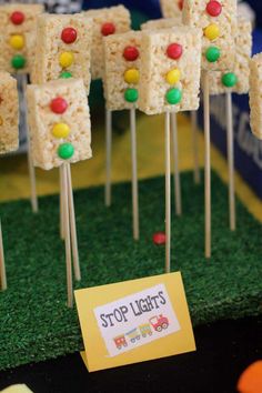 marshmallow treats are arranged on sticks with candy