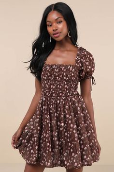 You'll be the first thing on your sweetie's mind in the Lulus Delightful Crush Brown Floral Smocked Puff Sleeve Mini Dress! Lightweight woven fabric, with a burnout design and ditsy floral print throughout, shapes short puff sleeves with elastic cuffs and bow details. Ruffle-trimmed square neckline tops a smocked bodice with a fitted waist. Flaring skirt finishes at a bubble-style mini hem. Fit: This garment fits true to size. Length: Mid-thigh. Size medium measures 26.5" from shoulder to hem. B Cute Fitted Smocked Mini Dress, Cute Dresses With Smocked Bodice For Brunch, Cute Fitted Smocked Dress With Ruffle Hem, Cute Floral Print Smocked Dress For Garden Party, Cute Mini Smocked Dress With Smocked Bodice, Cute Short Sleeve Smocked Dress For Spring, Cute Spring Smocked Dress, Cute Smocked Puff Sleeve Fitted Dress, Cute Fitted Smocked Dress With Puff Sleeves