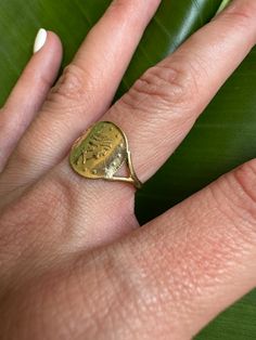 Vintage 9k Coin Signet Ring with Wishbone Shoulders Description: This vintage 9k coin signet ring features detailed wishbone shoulders, adding a unique and bold touch to your collection. Sized at 6.5 and weighing 1.42g, the coin measures 12.8mm and showcases British hallmarks. This piece is perfect for adding a statement to any outfit. As with all our pieces, this ring is a rare find—once it's gone, it's gone. Choosing this piece helps you stand out from the crowd while supporting sustainable pr Antique Coin-shape Engraved Signet Ring, Antique Coin Shaped Engraved Signet Ring, Antique Engraved Coin Signet Ring, Vintage Tarnish-resistant Signet Ring, Oval Stamped 14k Gold Signet Ring, Vintage Engraved Round Ring, Tarnish Resistant, Oval 14k Gold Stamped Signet Ring, Vintage Oval Signet Ring, Tarnish Resistant, Antique Tarnish Resistant Signet Ring For Anniversary