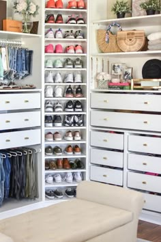 an organized closet with white drawers and lots of shoes on the shelves in front of it