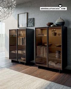 an empty room with some books and vases on the shelves next to each other