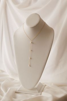 If you're looking for a statement for your big day, look no further. Our Pearl Back Drop Necklace features a 5" front drop and a 7" back drop, adorned with hand fastened freshwater pearls to finish the look. This piece is classic, elegant, and sure to make you like the beautiful bride you are on your special day. Includes 10 freshwater pearls + 16" neck length of 14k gold-filled cable cha Elegant Pearl White Backdrop Necklace With Pearl Drop, Elegant Dangle Backdrop Necklace With Pearl Drop, Wedding Pearl Lariat Necklace With Dangle, Gold Pearl Drop Backdrop Necklace, Long Drop Pearl Pendant Necklace For Wedding, Gold Backdrop Necklace With Pearl Drop, Elegant Pearl Backdrop Necklace With Pearl Drop, Formal Drop Pearl Necklace With Pearl Chain, Elegant Pearl Lariat Necklace For Wedding