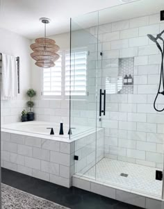 a white tiled bathroom with black accents