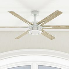 a white ceiling fan mounted to the side of a door with two wooden blades on it