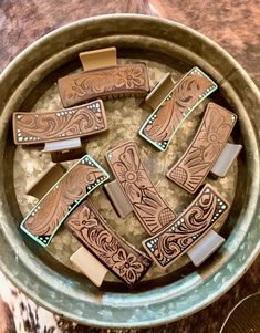 a bowl filled with lots of different types of wooden items on top of a table