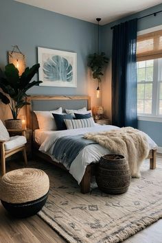 a bedroom with blue walls and white bedding