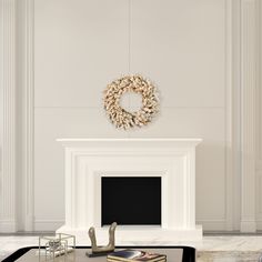 a living room filled with furniture and a fire place in front of a white wall