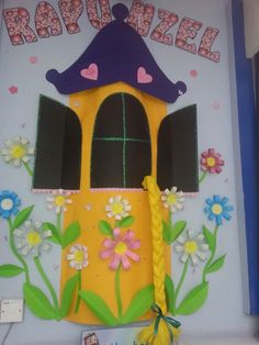 this is an image of a door decorated with flowers and a little house on it