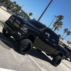 a large black truck parked in a parking lot