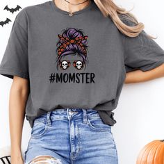 This fun Momster Halloween shirt is a perfect addition to your spooky season wardrobe. Whether you're celebrating with your little monsters, getting into the Halloween spirit, or just embracing your playful side, this shirt captures the essence of being a mom with a touch of humor and fun. It's also a fantastic gift for any mom who loves Halloween and enjoys a good laugh. Crafted from the highest quality fabric, this shirt offers an incredibly soft, breathable, and comfortable fit, with advanced Funny Halloween Tops With Skull Print, Funny Halloween Top With Skull Print, Funny Skull Print Tops For Halloween, Funny Halloween Skull Print Top, Fall Novelty Cotton Tops, Novelty Cotton Tops For Fall, Fun Halloween Shirt With Cartoon Print, Funny Print Halloween Shirt, Funny Halloween Print Tops