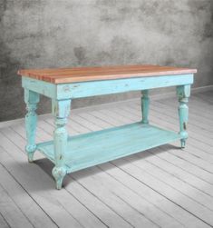 an old blue bench with wooden top on the floor